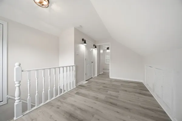a bathroom with a white bath tub a sink and a shower