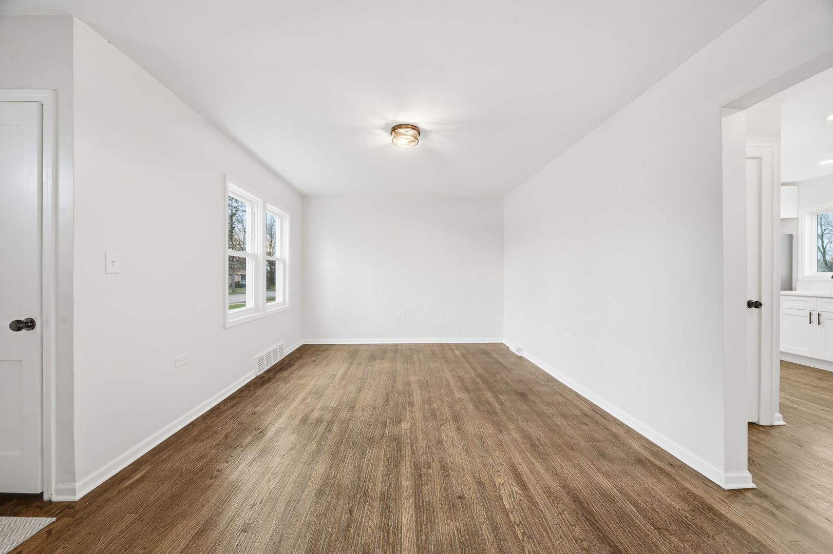17909 Rose Street Lansing, IL 60438 - Photo 6 of 27 an empty room with wooden floor and windows