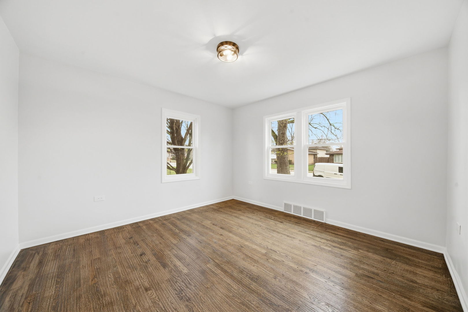 17909 Rose Street Lansing, IL 60438 - Photo 8 of 27 an empty room with wooden floor and windows