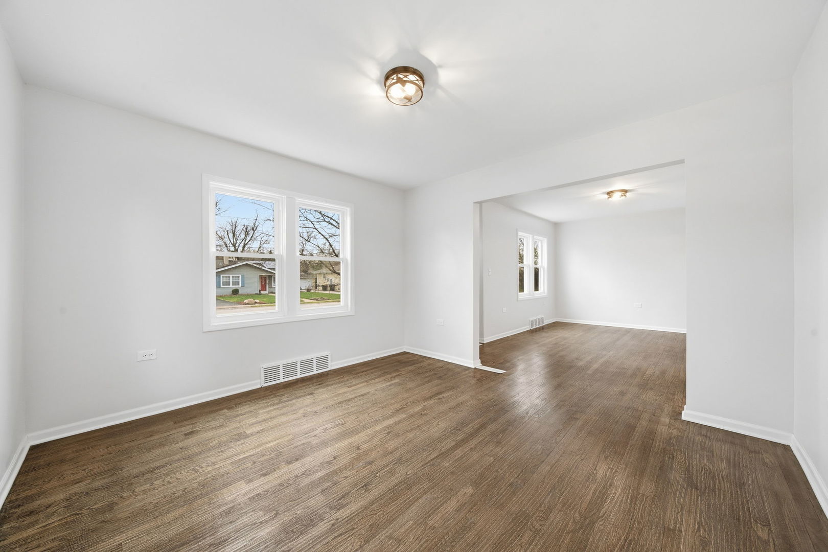 17909 Rose Street Lansing, IL 60438 - Photo 9 of 27 an empty room with wooden floor and windows