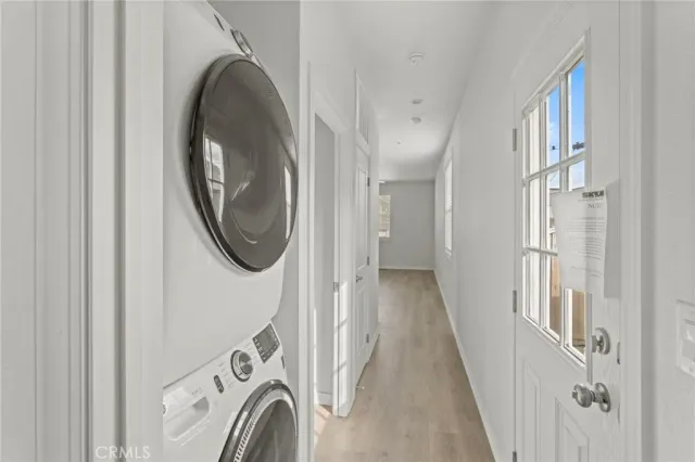 an empty room with a window and a ceiling fan