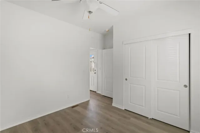 a bathroom with a toilet sink vanity and mirror
