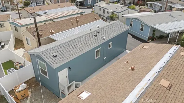 an aerial view of a house with a garden and mountain view