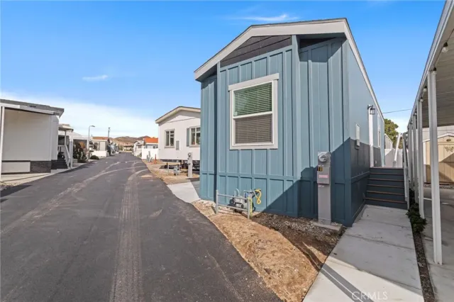 an empty room with a kitchen and a stove top oven