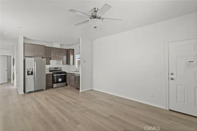a kitchen with stainless steel appliances granite countertop a refrigerator and a stove