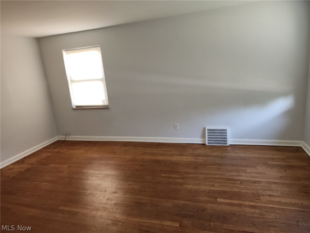 4114 Ellison Road Cleveland, OH 44121 - Photo 10 of 19 Spare room with dark hardwood / wood-style floors