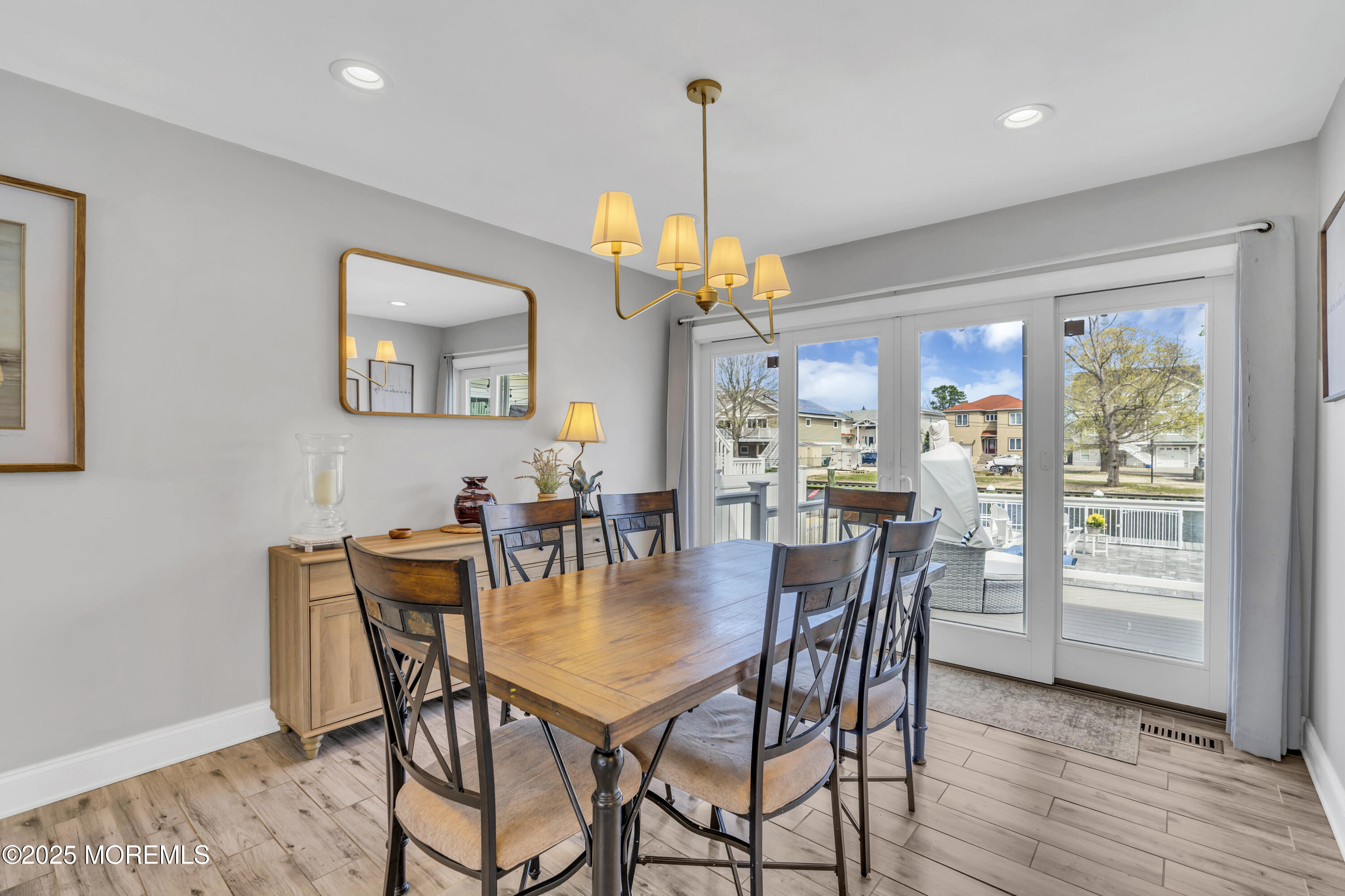 650 Drum Point Road Brick, NJ 08723 - Photo 21 of 42 a dining room with furniture a chandelier and wooden floor