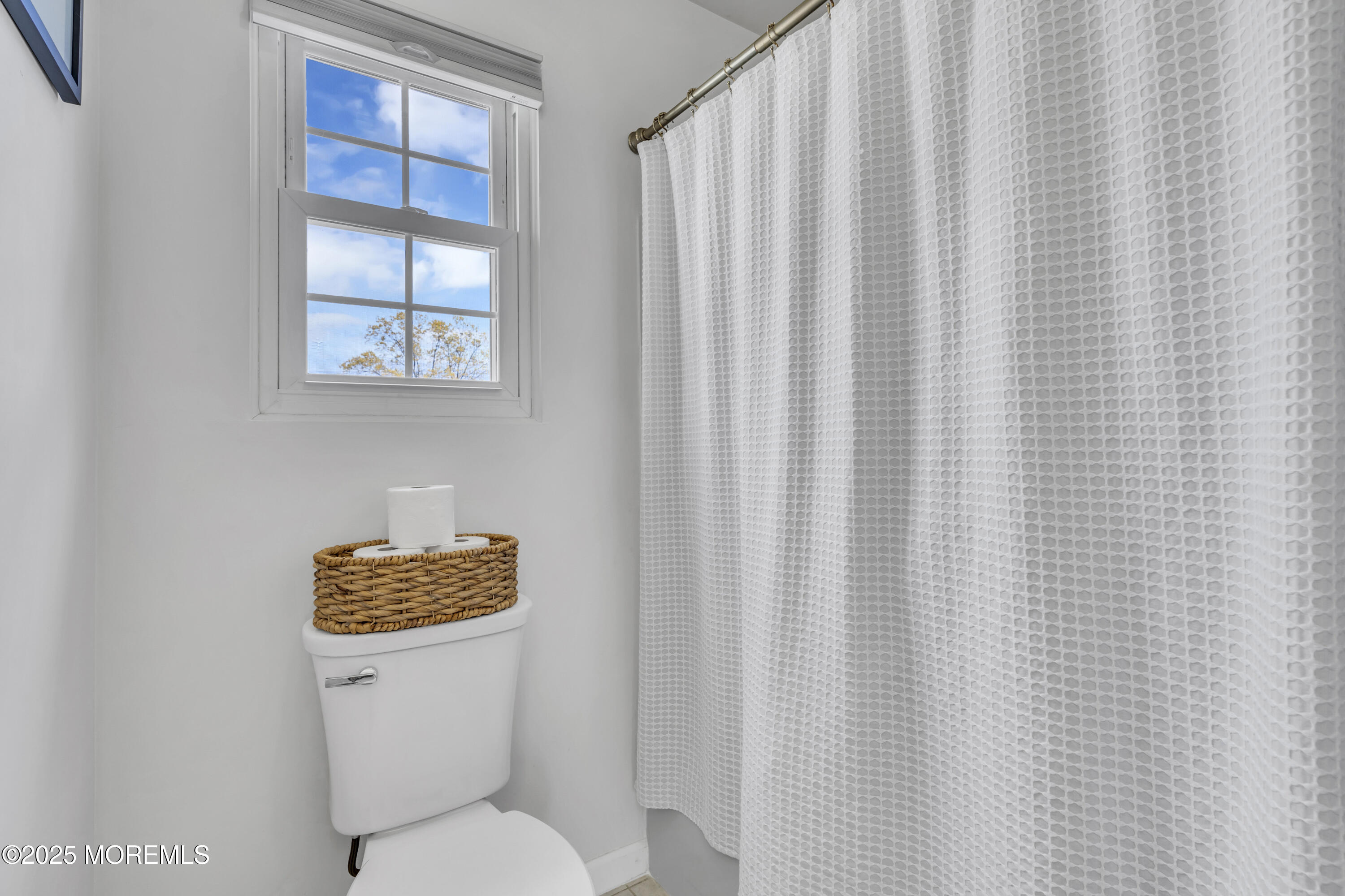 650 Drum Point Road Brick, NJ 08723 - Photo 37 of 42 a white toilet sitting next to a blue curtain
