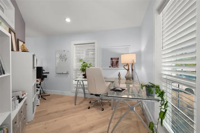 a view of a hallway with wooden floor and furniture