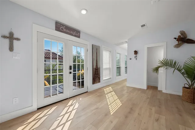 a spacious bedroom with a bed and a flat screen tv