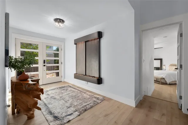 a view of an entryway with wooden floor