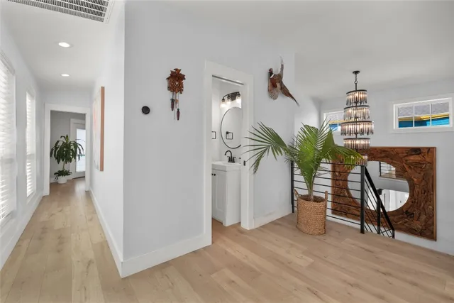 a bedroom with a large bed a flat tv screen and a large window