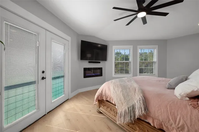 a spacious bedroom with a bed and a lamp