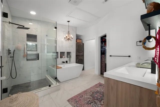 a spacious bedroom with a bed a couch and a flat screen tv