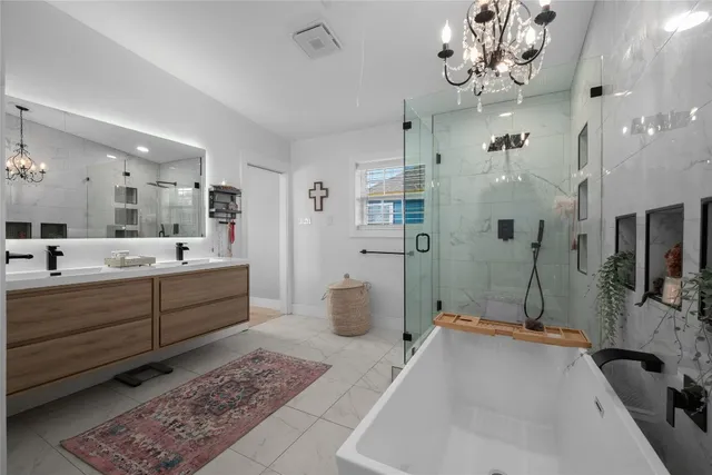 a bedroom with a bed couch and flat screen tv