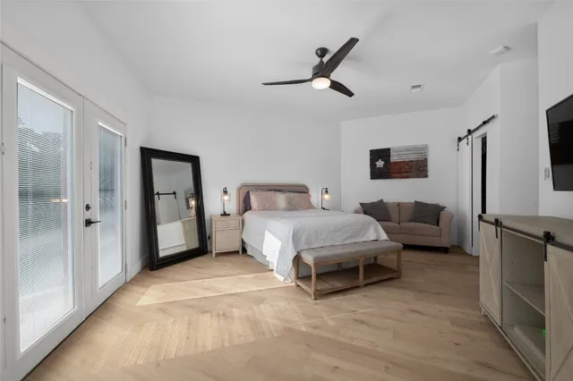 a bedroom with furniture and a flat screen tv