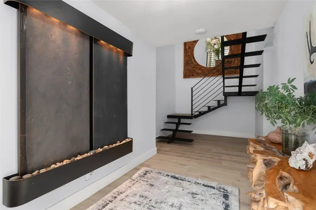 a living room with furniture a dining table and a potted plant