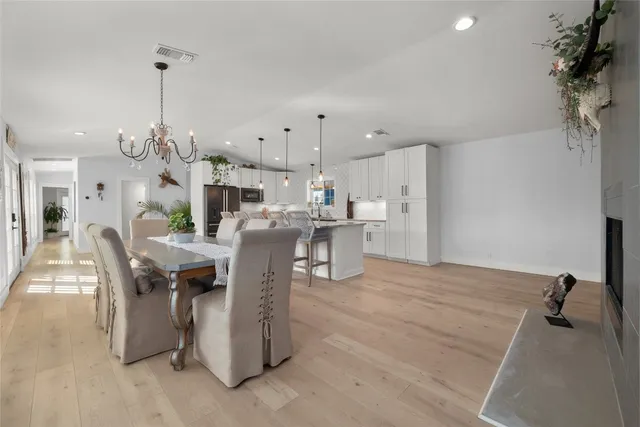 a kitchen with kitchen island a wooden floor and white appliances