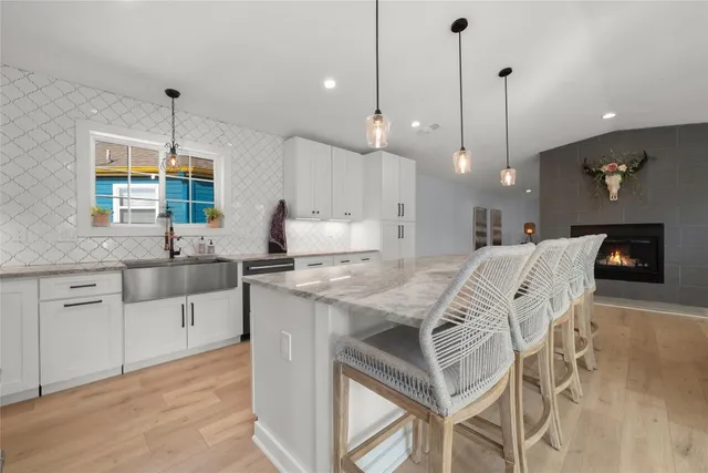 a large kitchen with kitchen island granite countertop lots of counter space a sink appliances and cabinets