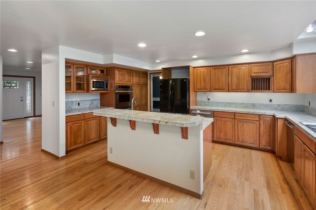 16045 Southeast 149th Street Renton, WA 98059 - Photo 15 of 39 a kitchen with stainless steel appliances granite countertop a stove and a sink