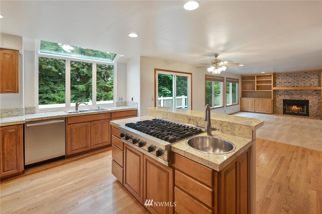16045 Southeast 149th Street Renton, WA 98059 - Photo 17 of 39 a kitchen with granite countertop a sink and a stove top oven