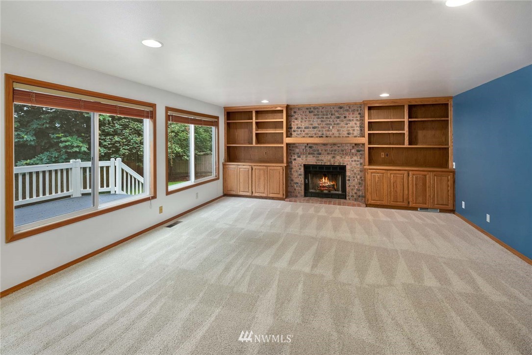 16045 Southeast 149th Street Renton, WA 98059 - Photo 19 of 39 wooden floor fireplace and windows in an empty room