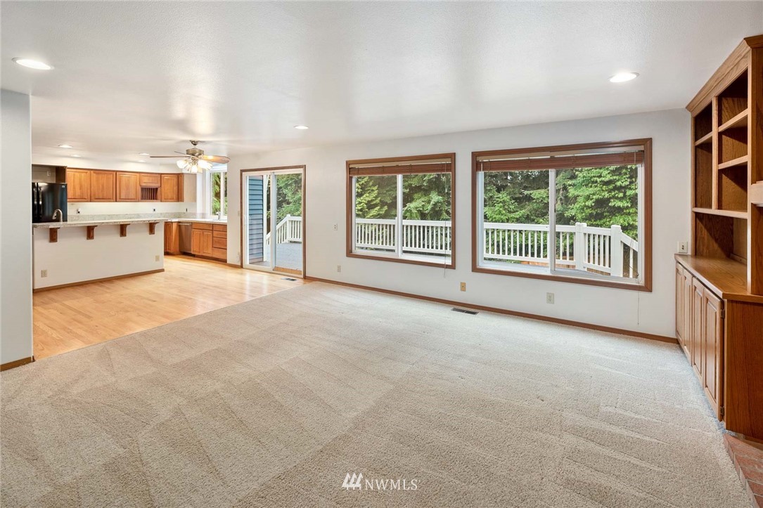 16045 Southeast 149th Street Renton, WA 98059 - Photo 20 of 39 a view of an empty room with a window and a kitchen