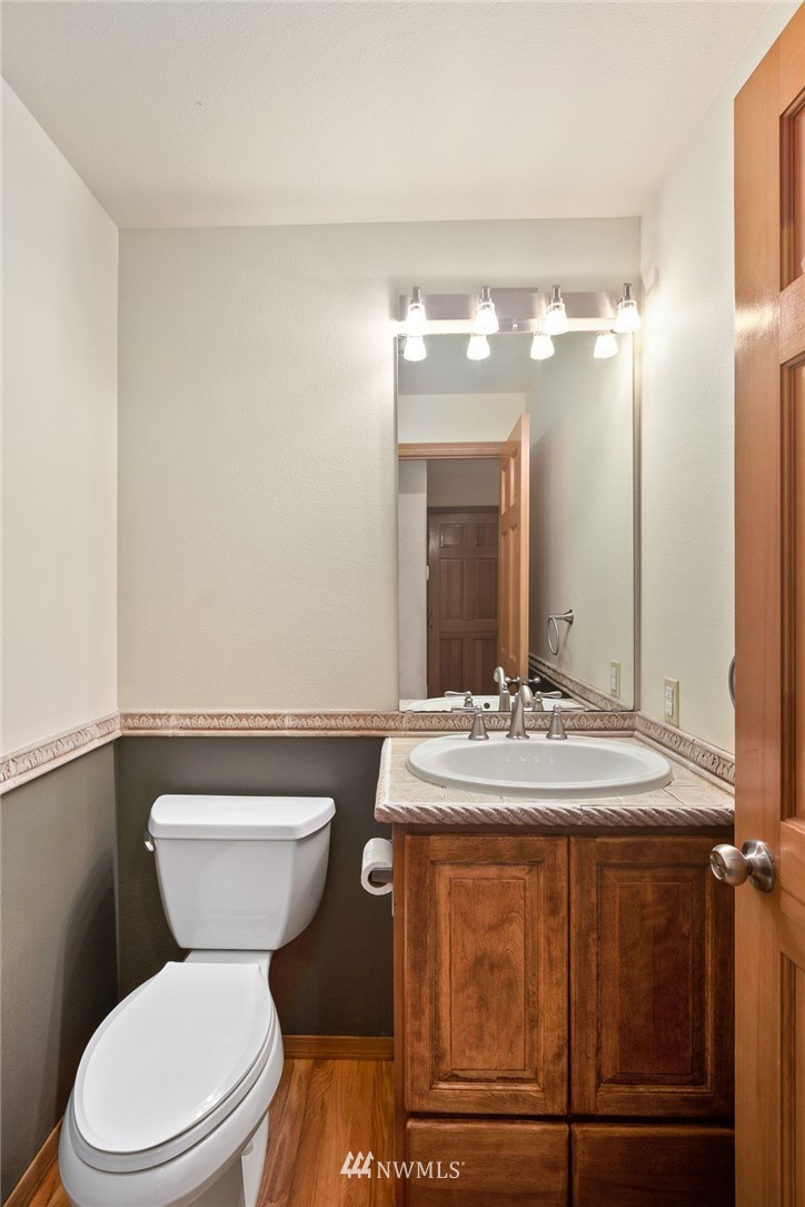 16045 Southeast 149th Street Renton, WA 98059 - Photo 22 of 39 a bathroom with a granite countertop toilet sink and mirror