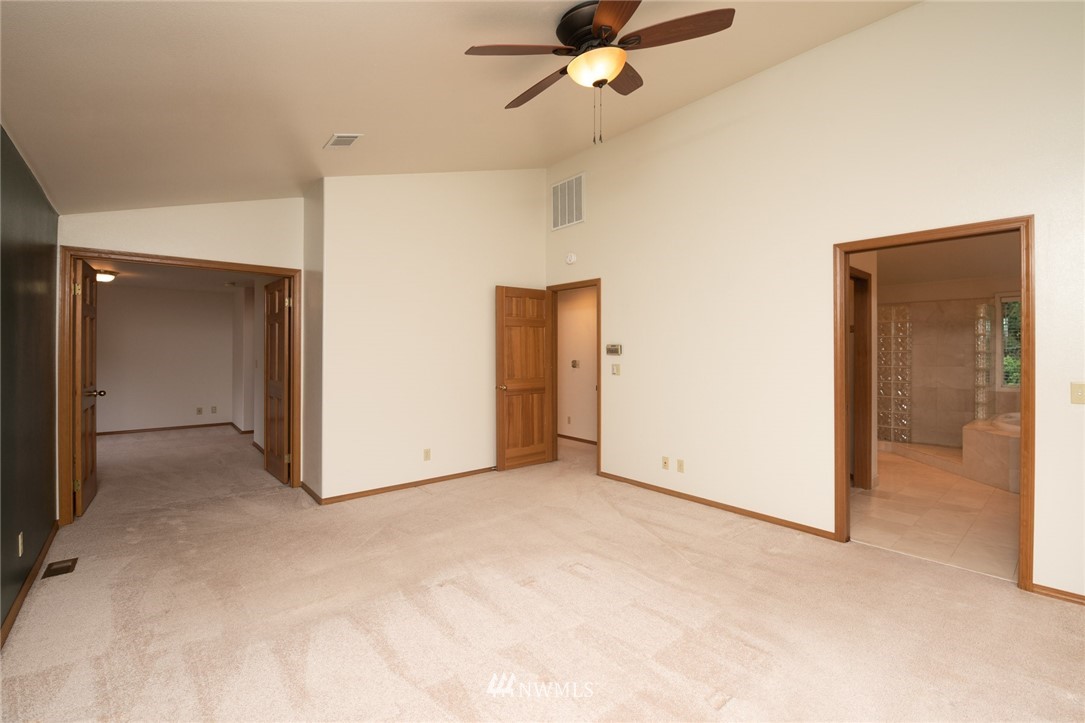 16045 Southeast 149th Street Renton, WA 98059 - Photo 26 of 39 an empty room with closet and a chandelier fan