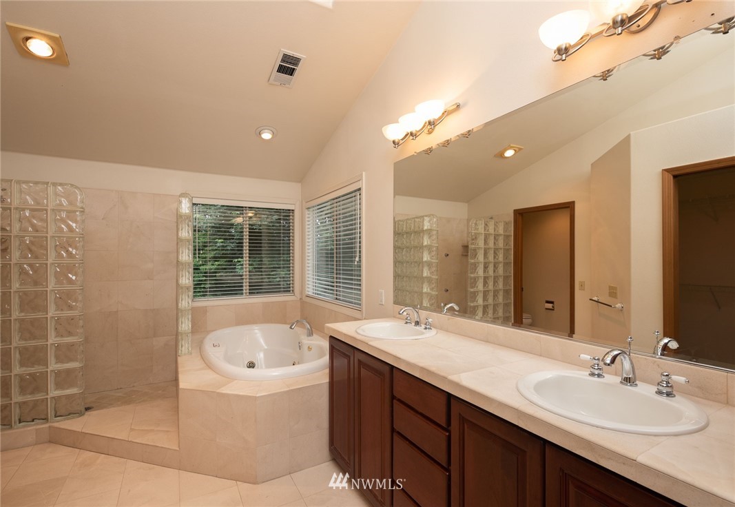 16045 Southeast 149th Street Renton, WA 98059 - Photo 27 of 39 a bathroom with a tub sink shower and mirror