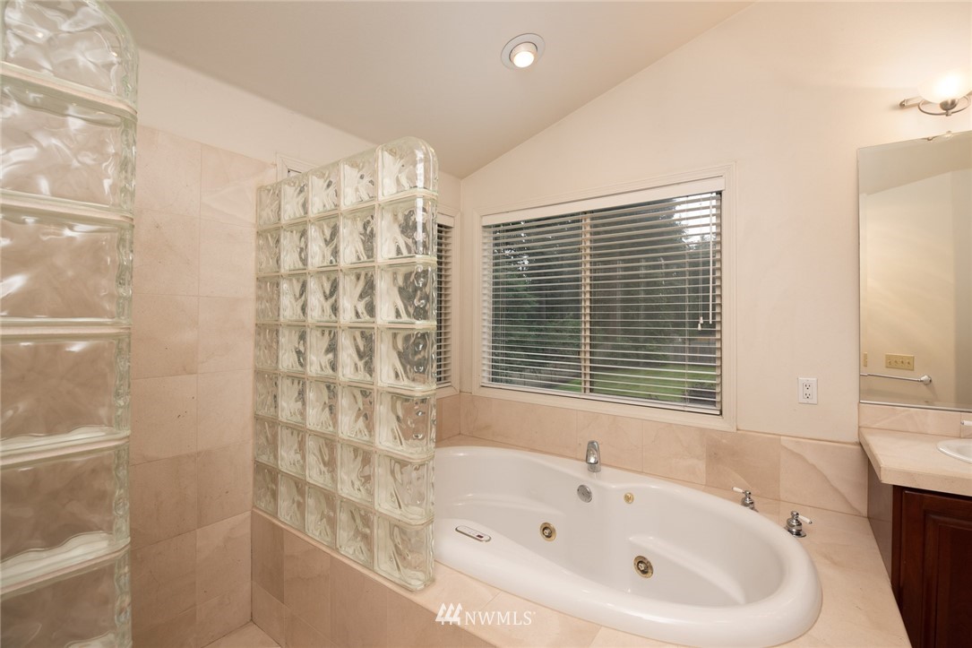 16045 Southeast 149th Street Renton, WA 98059 - Photo 28 of 39 a bathroom with a bathtub and shower