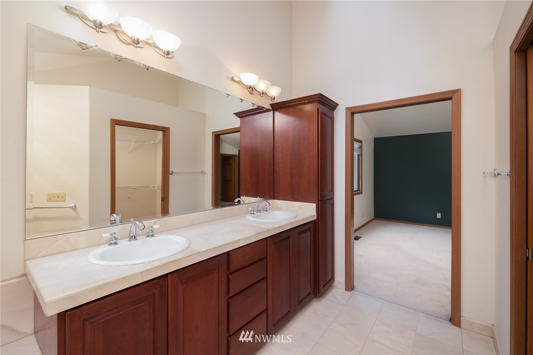 16045 Southeast 149th Street Renton, WA 98059 - Photo 29 of 39 a bathroom with a sink vanity and a mirror