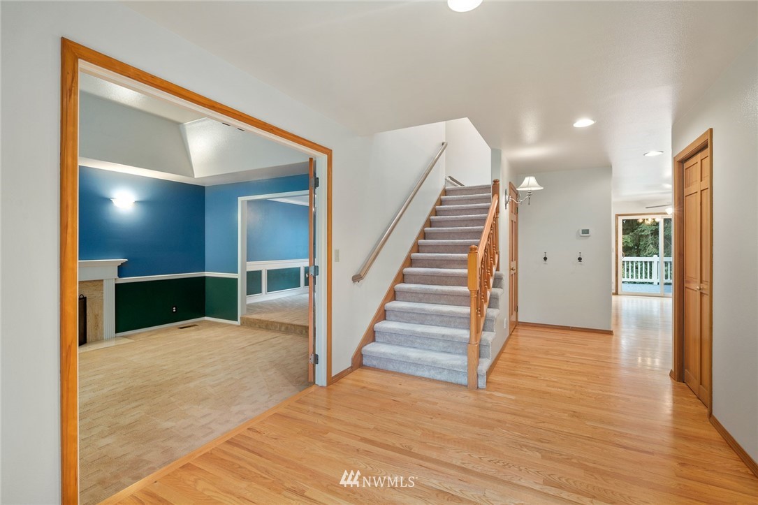 16045 Southeast 149th Street Renton, WA 98059 - Photo 6 of 39 a view of a hallway with wooden floor and staircase