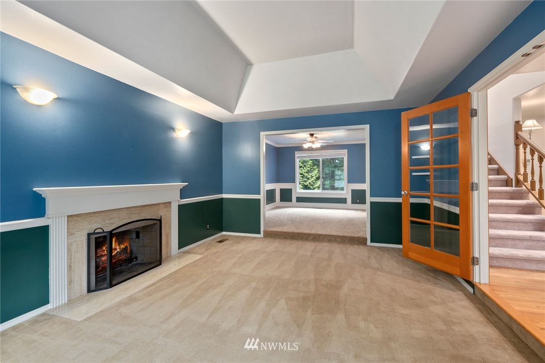 16045 Southeast 149th Street Renton, WA 98059 - Photo 7 of 39 a view of an empty room with a fireplace and a window