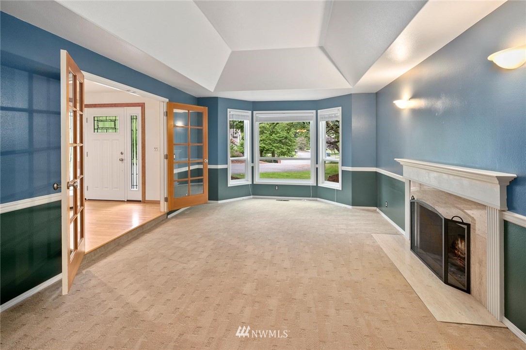 16045 Southeast 149th Street Renton, WA 98059 - Photo 8 of 39 an empty room with windows and fireplace