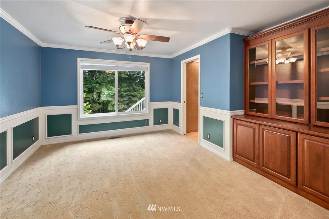 16045 Southeast 149th Street Renton, WA 98059 - Photo 9 of 39 a view of an empty room with a fireplace and a large window