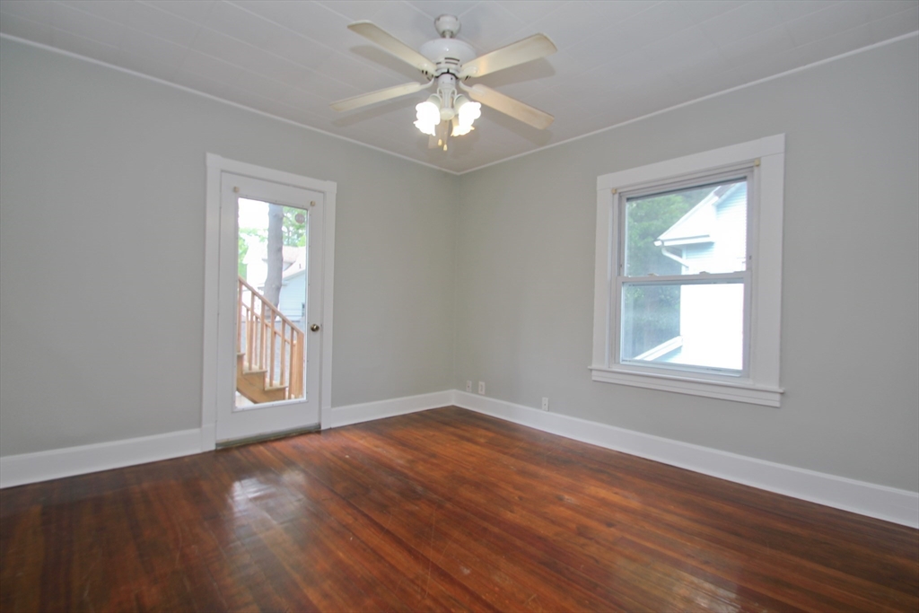38 Virginia Street Springfield, MA 01108 - Photo 20 of 42 a view of an empty room with a window and wooden floor