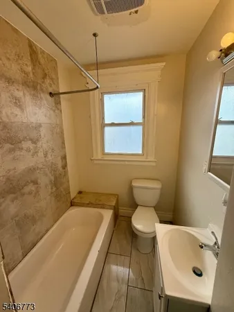 a bathroom with a toilet sink and bathtub