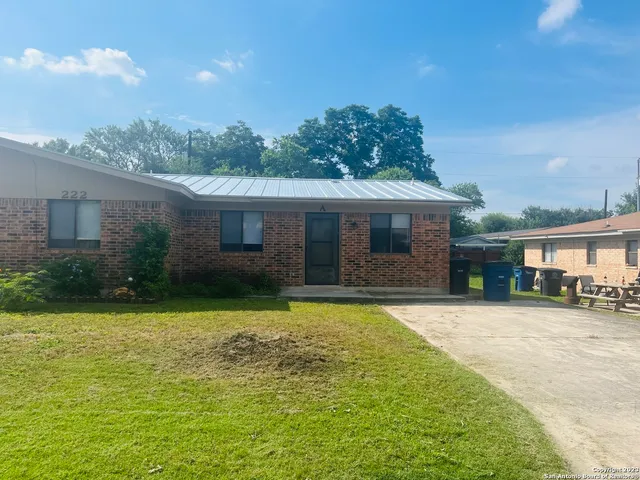 a front view of a house with a garden and yard