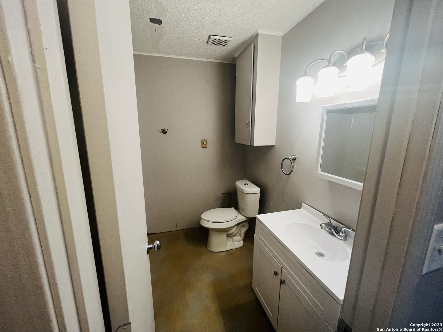 222 Redbud Lane, Unit A New Braunfels, TX 78130 - Photo 11 of 16 a bathroom with a toilet sink and a mirror