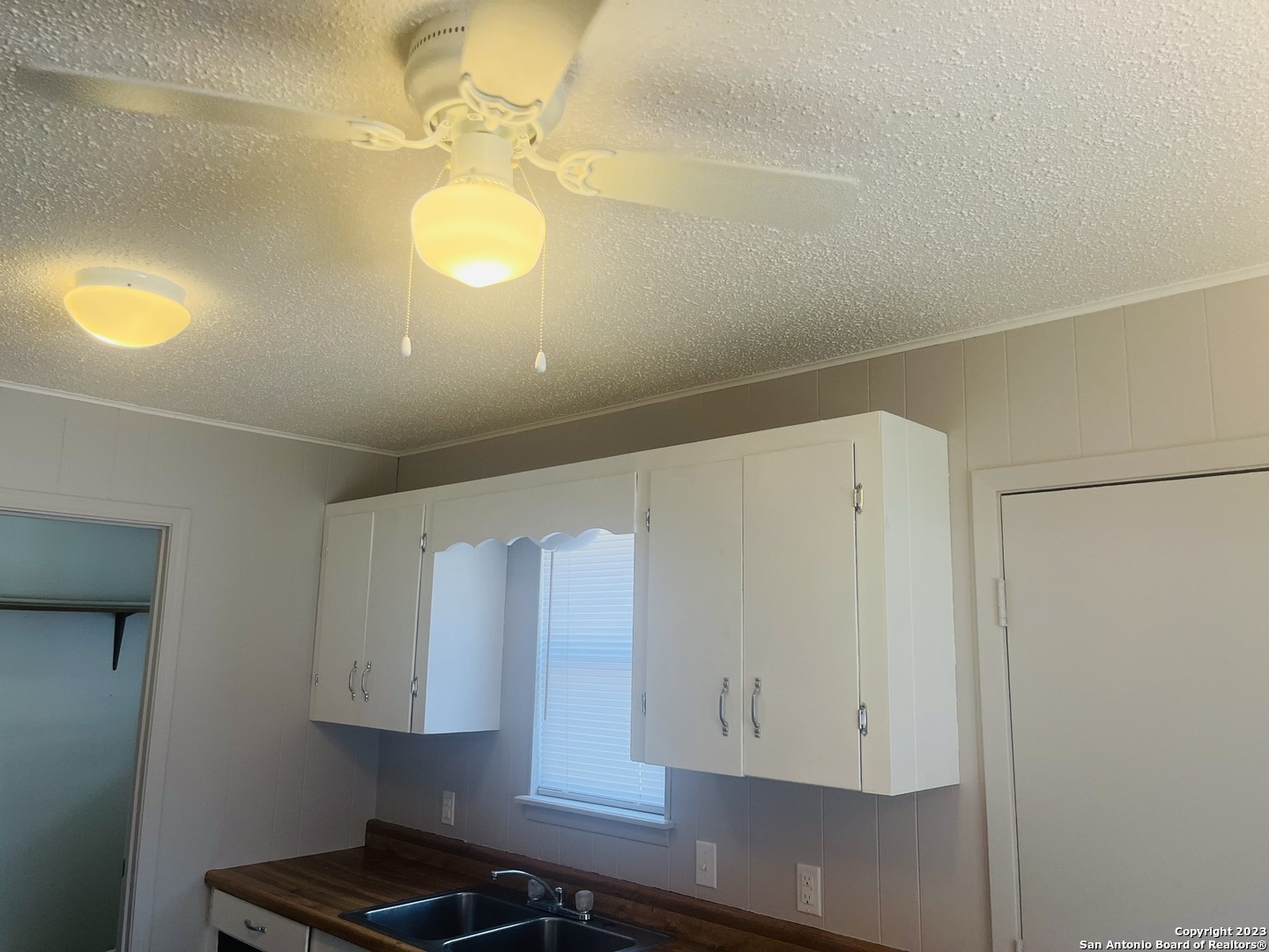 222 Redbud Lane, Unit A New Braunfels, TX 78130 - Photo 6 of 16 a view of kitchen cabinets and window