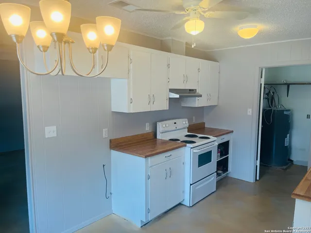 a kitchen with cabinets and stainless steel appliances