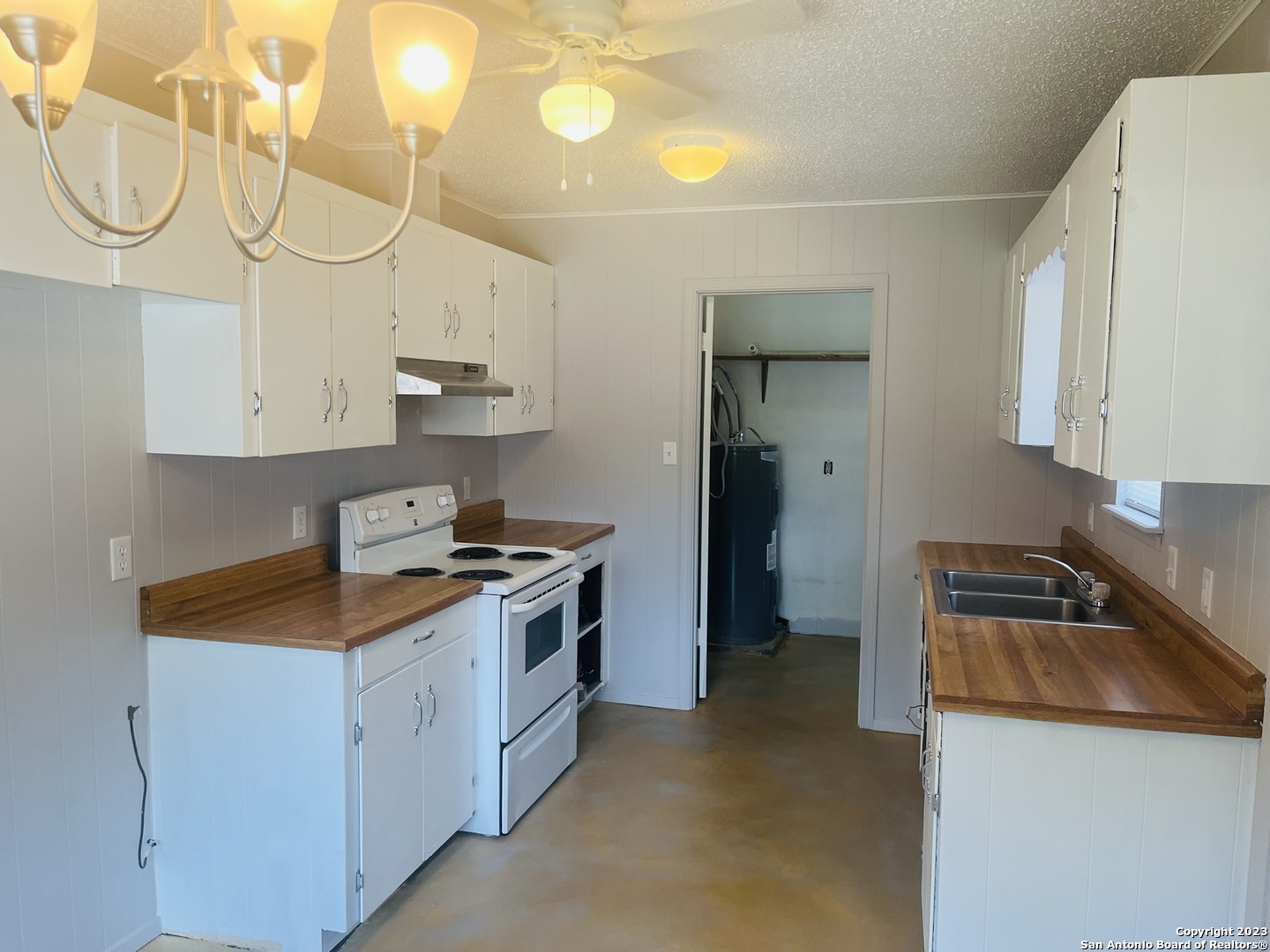 222 Redbud Lane, Unit A New Braunfels, TX 78130 - Photo 8 of 16 a kitchen with stainless steel appliances granite countertop a sink a stove and a refrigerator