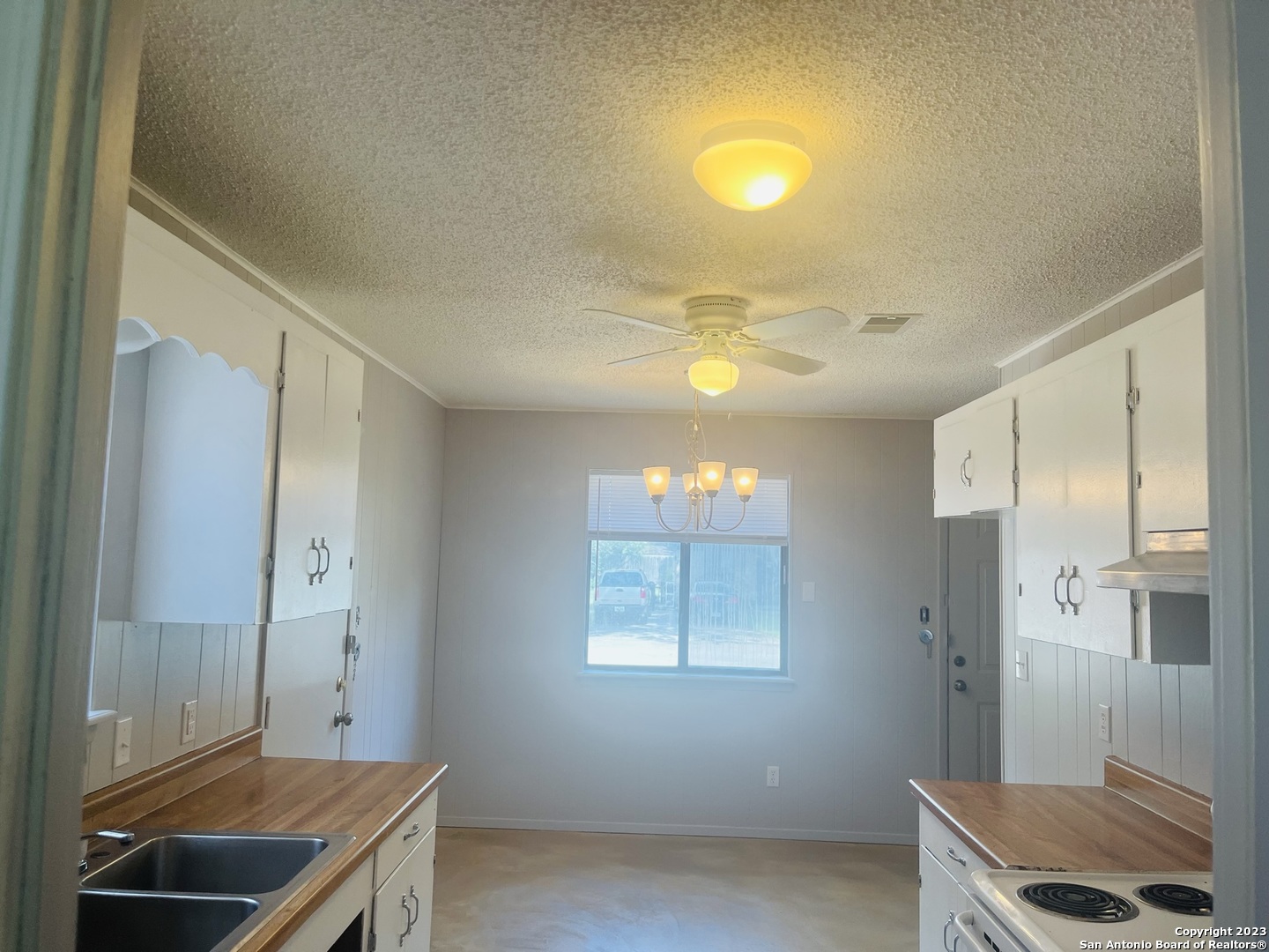 222 Redbud Lane, Unit A New Braunfels, TX 78130 - Photo 9 of 16 a room with a chair and a chandelier