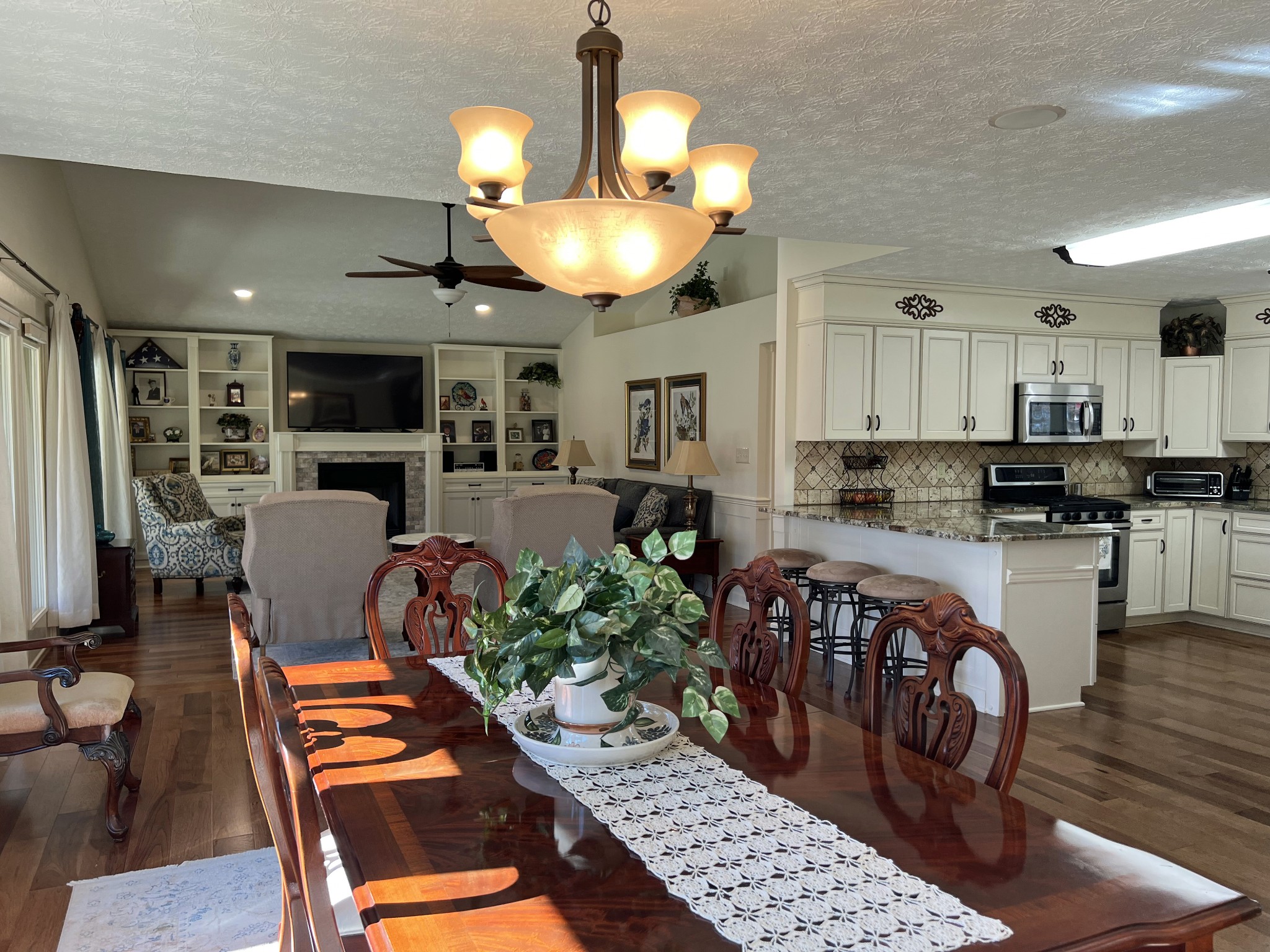 425 Alvaton- Greenhill Road Bowling Green, KY 42103 - Photo 5 of 68 a kitchen with stainless steel appliances kitchen island granite countertop a refrigerator a stove top oven a sink dishwasher and white cabinets with wooden floor