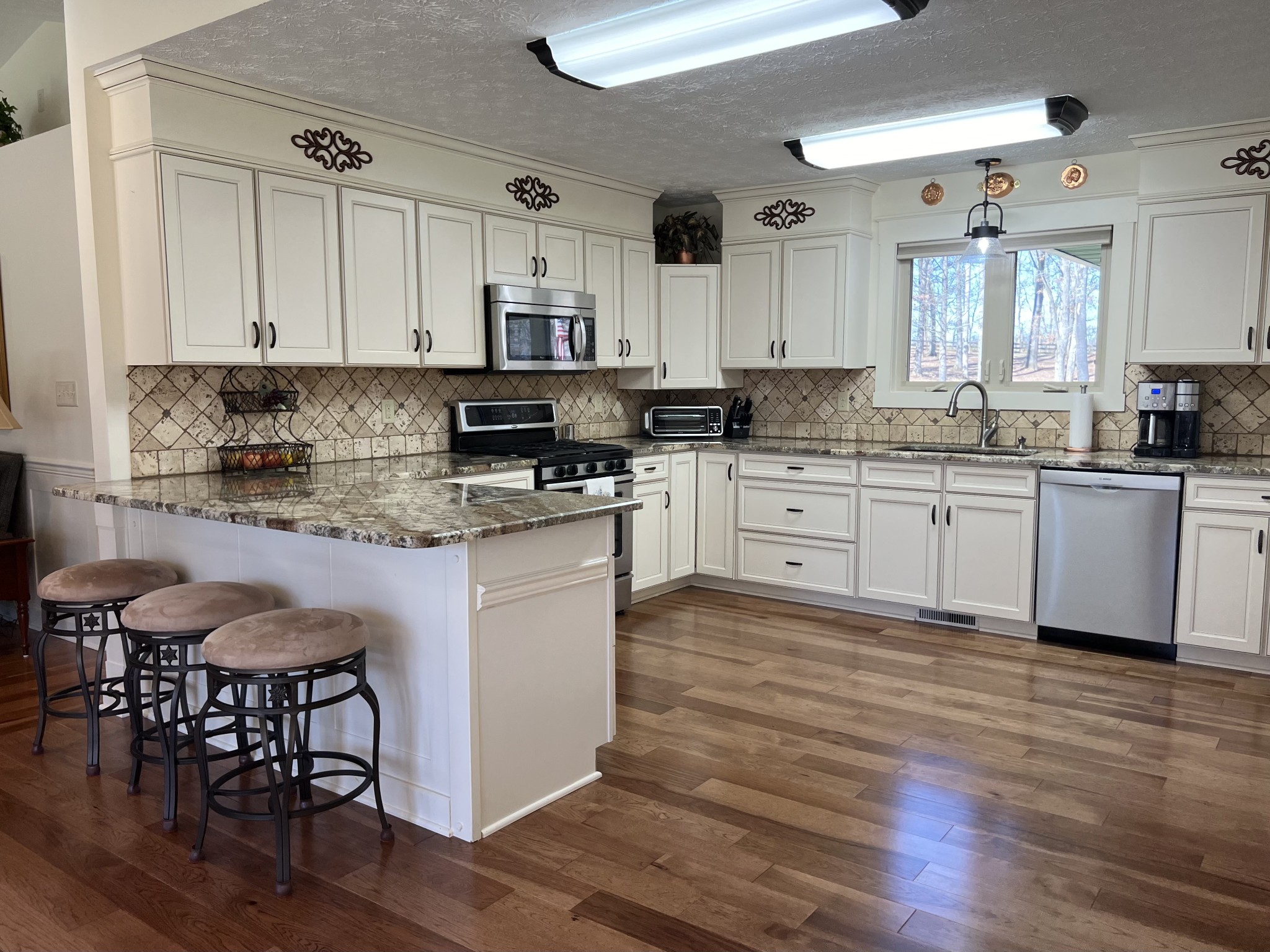 425 Alvaton- Greenhill Road Bowling Green, KY 42103 - Photo 7 of 68 a large kitchen with stainless steel appliances granite countertop a stove top oven a sink a dining table and chairs