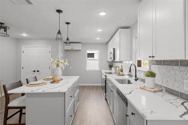 a kitchen with a sink stove and cabinets