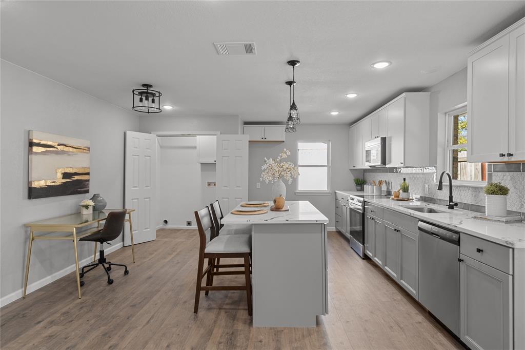 2602 Taylor Street Commerce, TX 75428 - Photo 13 of 37 a kitchen with sink cabinets and dining table