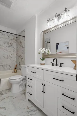 a bathroom with a sink a toilet and vanity