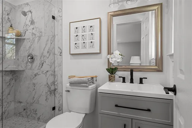 a bathroom with a toilet sink and mirror